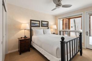 a bedroom with a large bed and a window at Spring Street Unit 629, 2BR Condo w/ Mountain Views and Door Step Access to Shops & Restaurants in Aspen