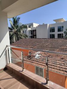 a balcony of a building with a roof at Hotel heaven by sky in Calangute