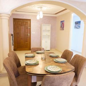 a dining room with a wooden table and chairs at Luxury Apartement in City Center F2 in Tangier