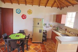 a kitchen with a table and a refrigerator in it at Villa Bonita in Bucaramanga