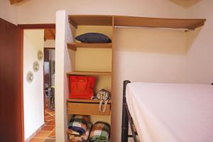 sypialnia z łóżkiem i pokój z półkami w obiekcie Villa Bonita w mieście Bucaramanga