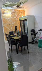 een eetkamer met een tafel en stoelen in een kamer bij Refuge celeste : Votre Havre Numerique in Lomé