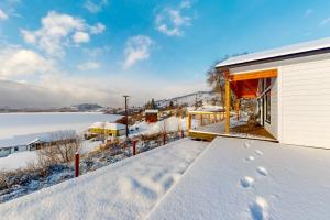 a house with a deck in the snow at Lakeview Retreat in Manson