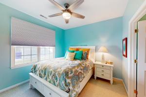 a blue bedroom with a bed and a ceiling fan at White Creek at Bethany --- 30930 Sea Breeze Ln in Ocean View +31 photos
