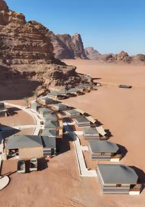 an aerial view of a desert with a row of tents at Desert Magic Camp & Resort in Wadi Rum