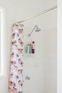 a shower curtain with hearts on it in a bathroom at Shoreline Sanctuary - A Retro Family Beach Shack in Somers