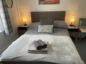 a bed with two towels and a pillow that reads the only guest at Bella Vista in Paignton