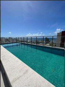a swimming pool on the roof of a building at Apto 400 mt da orla in Salvador