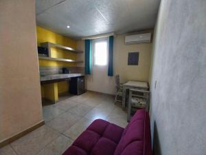 a living room with a purple couch and a table at Santa Maria del Cabo in San José del Cabo