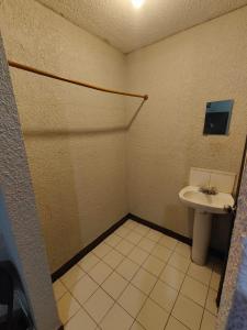 a bathroom with a toilet and a sink at Hotel Chinesca in Mexicali