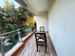 a wooden balcony with a chair on top of it at Hotel heaven by sky in Calangute
