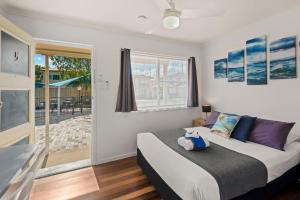 a bedroom with a bed and a large window at Pacific Motor Inn in Evans Head +13 photos
