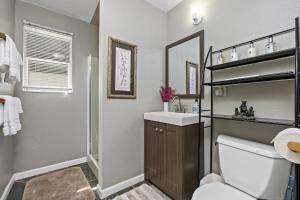 a bathroom with a toilet and a sink and a mirror at Mountain Meadows Inn & Chalet Suites in Ashford +37 photos