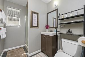 a bathroom with a toilet and a sink and a mirror at Mountain Meadows Inn & Chalet Suites in Ashford
