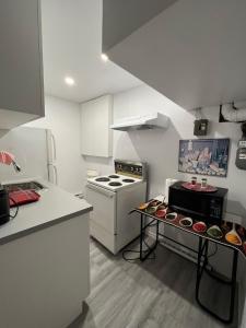 a kitchen with a stove and a counter with cupcakes at Bertha's charming urban retreat in Laval