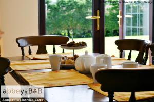 a wooden table with food on top of it at Abbeyside B&B in Ballintober