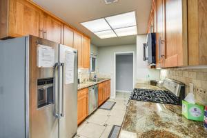 a kitchen with wooden cabinets and stainless steel appliances at Stylish San Jose Retreat - 7 Mi to Downtown in San Jose