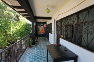 a balcony with a bench and a painting on the wall at LAM Casa Hostal in San Cristóbal de Las Casas