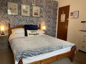 a bedroom with a bed with a pillow on it at Bella Vista in Paignton