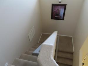 a stairway with a white stair case and a picture at Beautiful, spacious home in ABQ in Albuquerque