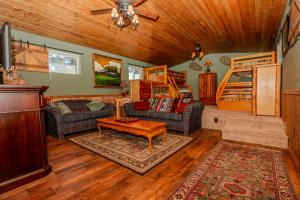a living room with two couches and a bunk bed at The Honky Tonk Cabin in Long Valley Junction