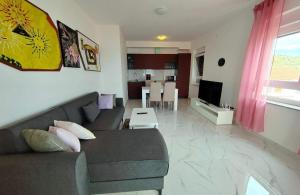 a living room with a couch and a table at Apartments by the sea Barbat, Rab - 22251 in Rab