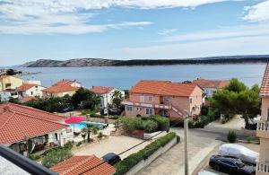 a view of a town with a body of water at Apartments by the sea Barbat, Rab - 22251 in Rab