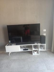 a large flat screen tv on a white entertainment center at Il monte galala -Ain El Sokhna in Ain Sokhna