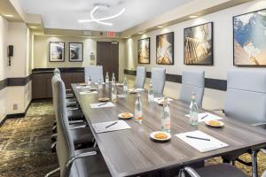 a conference room with a long table and chairs at DoubleTree by Hilton Roseville Minneapolis in Roseville