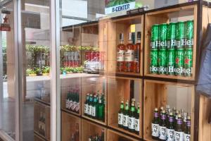 a display case in a store filled with lots of soda bottles at Student Haven Compact Studio at B Residence BSD in Tjilandak