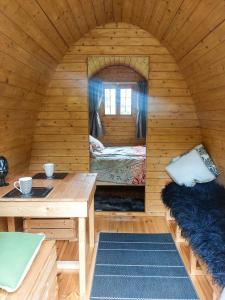 a room with a bed and a desk in a cabin at Ashley Gorge Holiday Park in Oxford