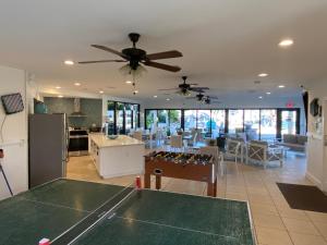 a living room with a ping pong table and a ceiling fan at Moon Bay Condo, Paradise Found in Sunny Key Largo, Florida in Key Largo
