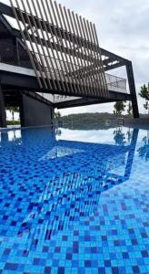 a swimming pool with a bench in the middle of it at NurAz Residensi Adelia2, Bangi Avenue, Free wifi, Pool in Kajang