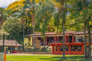 ein Haus mit Palmen davor in der Unterkunft Hotel Estância Santa Isabel in Santa Isabel