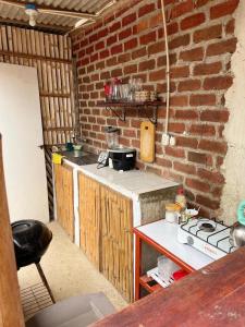 a kitchen with a brick wall and a counter top at Vista Palmeras in Zorritos