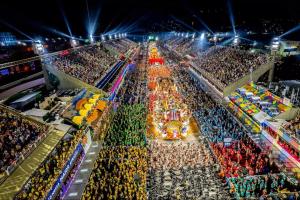 a large crowd of people at a carnival at night at OBO Casa • Modern Lux Design Loft • Ipanema Beach in Rio de Janeiro +100 photos