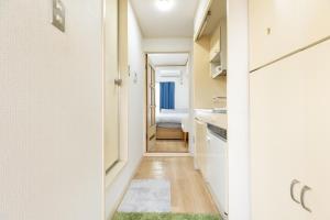 a hallway with a kitchen and a bedroom at Inoguchi View Heights in Itsukaichi