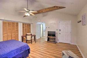 a bedroom with a bed and a table and a ceiling fan at Escambia in Tallahassee
