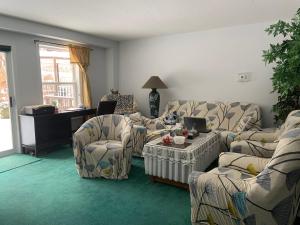 sala de estar con sofás, mesa y sillas en Susan's Villa, en Niagara Falls