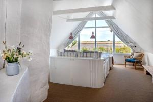 a living room with white furniture and a large window at Farmhouse near Malmö in Trelleborg