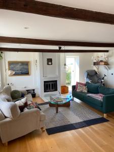 a living room with two couches and a table at Farmhouse near Malmö in Trelleborg