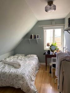 a bedroom with a bed and a desk and a window at Farmhouse near Malmö in Trelleborg