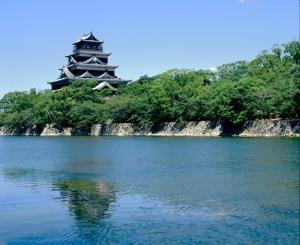 a pagoda sitting on top of a body of water at Inoguchi View Heights in Itsukaichi