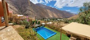 a swimming pool in a yard with mountains in the background at Domo Sol Del Valle in Horcon