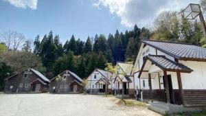 a group of houses in a row next to a parking lot at Tabino Camping Base Kami Yuland - Vacation STAY 52574v in Osaki