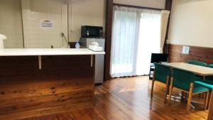 a room with a counter and chairs and a table at Tabino Camping Base Kami Yuland - Vacation STAY 52574v in Osaki
