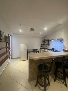 a kitchen with a counter and some chairs in a room at Vista Boquete Apartments in Bajo Boquete