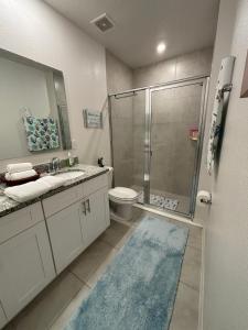 a bathroom with a shower and a toilet and a sink at Luxe Escape in De Leon Springs