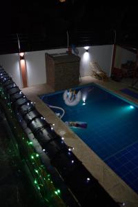 a swimming pool at night with lights around it at Casa privada en Tonsupa con piscina in Tonsupa