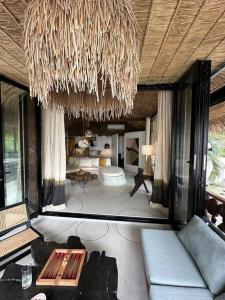 uma sala de estar com um sofá e um lustre em Happy Coco Monkey em Ko Phangan